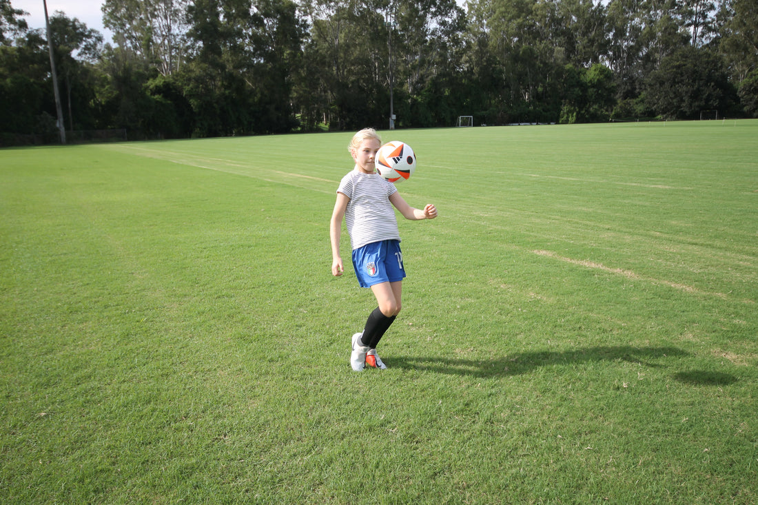 girl playing football wearing grip socks