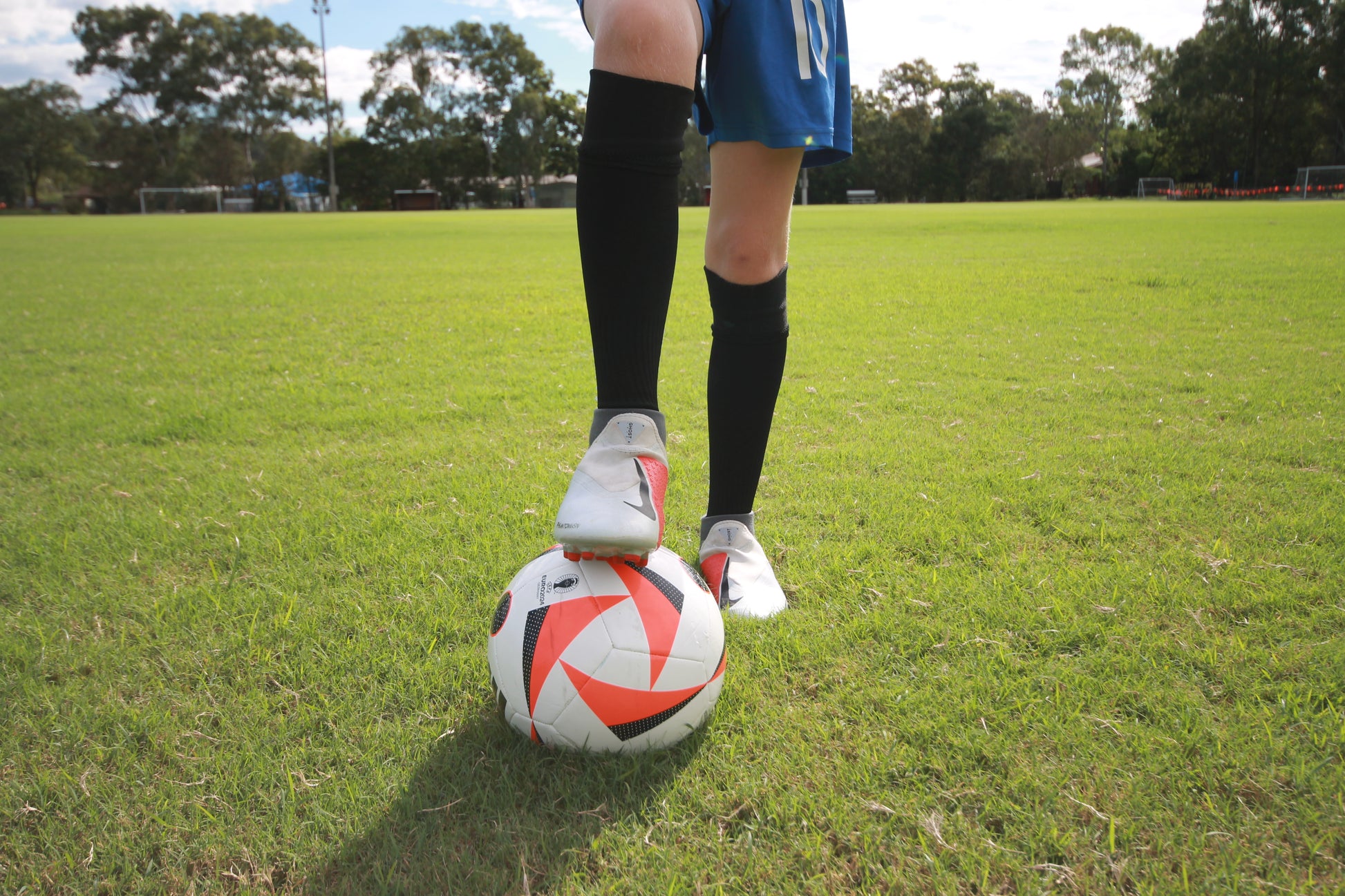 football player with long grip socks and soccer ball